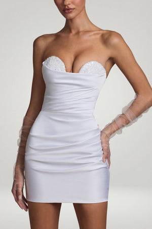 Oh Polly's Anna wearing the Tirza Mini Dress in White Satin fabric perfect for rooftop cocktails