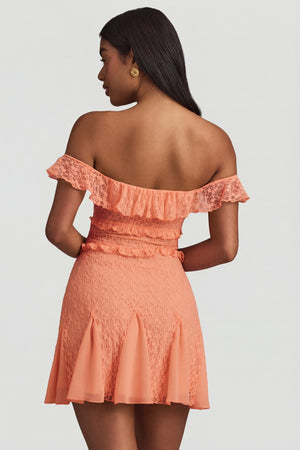 Oh Polly's Yarelis wearing the Nahida Mini Dress in Peach Stretch Lace fabric perfect for summer garden parties