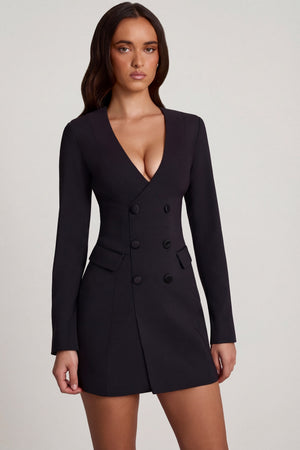Oh Polly's Roberta wearing the Samantae Mini Dress in Black Poly Span fabric perfect for holiday parties