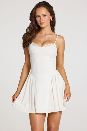 Oh Polly model Georgia wearing the Delphine Mini Dress in White Modal fabric perfect for summer garden parties