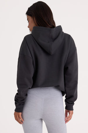 Bo+Tee model Kiele wearing the Varsity Hoodie in Black Cotton fabric perfect for casual outings
