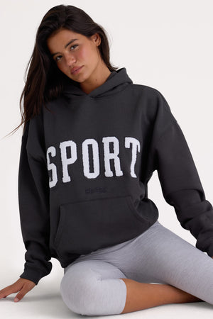 Bo+Tee model Kiele wearing the Varsity Hoodie in Black Cotton fabric perfect for weekend brunch