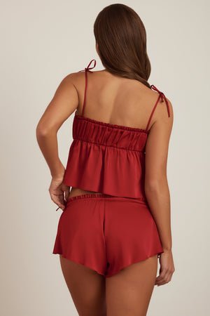 Oh Polly's Hayley wearing the Cinta Mini Shorts in Ruby Red Satin fabric perfect for date night style