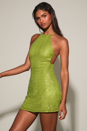 Oh Polly's Priscilla wearing the Farren Mini Dress in Pear Green Sequin fabric perfect for holiday events