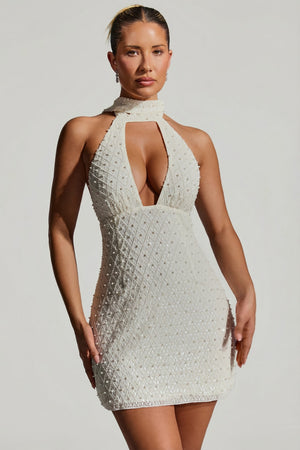 Oh Polly's Sierra Skye wearing the Henrietta Mini Dress in White Embellished fabric perfect for summer parties