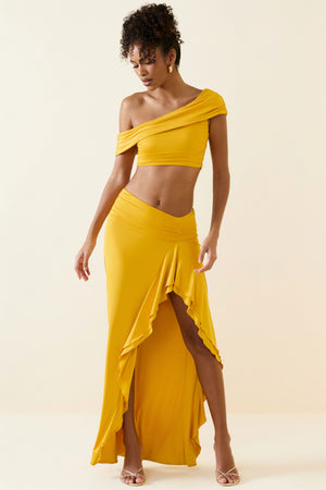 Oh Polly's Duda wearing the Imaan Maxi Skirt in Golden Yellow fabric perfect for summer beach parties