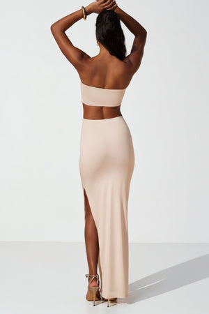 Oh Polly's Yarelis wearing the Juniper Maxi Dress in Ivory Slinky fabric perfect for rooftop celebrations