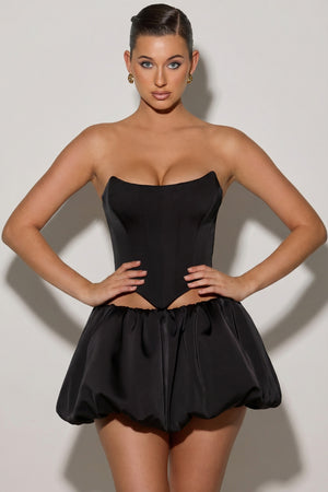 Oh Polly's Sarah wearing the Marnie Mini Skirt in Black Satin fabric perfect for a night out