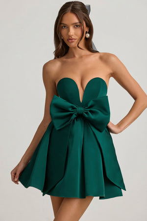 Oh Polly's Anna wearing the Norina Mini Dress in Emerald Green Satin, Taffeta fabric, perfect for holiday celebrations