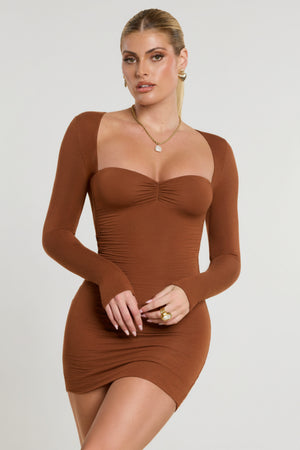 Oh Polly's Kiele wearing the Perrie Mini Dress in Chestnut Brown Modal fabric perfect for holiday events
