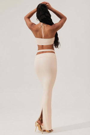 Oh Polly's Yarelis wearing the Sylas Maxi Skirt in Ivory Slinky fabric perfect for beachside dinners